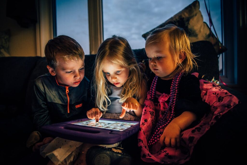 Screen time Photo of three-children-looking-at-a-tablet-computer