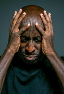 Man covering face with hands out of stress